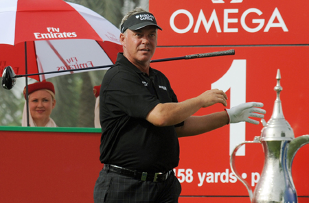 Northern Ireland’s Darren Clarke drops his club in dismay after a hitting a a disappointing shot during his first round at the Omega Dubai Desert Classic.