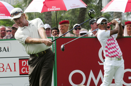 Spain’s Miguel Angel Jimenez and Thongchai Jaidee of Thailand warm up ahead of the final round of the Omega Dubai Desert Classic